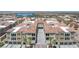 Aerial view of stunning condo building featuring an arched entryway and lush palm trees at 2555 Hampton Rd # 7304, Henderson, NV 89052