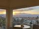 Balcony view showcasing the city skyline and mountains at sunset, with outdoor seating at 2555 Hampton Rd # 7304, Henderson, NV 89052