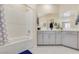 Bright bathroom with white cabinets, bath tub and shower head at 2555 Hampton Rd # 7304, Henderson, NV 89052
