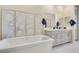 Luxurious bathroom with a soaking tub, gray vanity with dual sinks, and elegant fixtures for a spa-like feel at 2555 Hampton Rd # 7304, Henderson, NV 89052