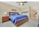 Well-lit bedroom with a plush bed, matching nightstands, and access to an adjacent hallway and bathroom at 2555 Hampton Rd # 7304, Henderson, NV 89052