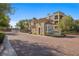 Beautiful community entrance with lush landscaping and building facade at 2555 Hampton Rd # 7304, Henderson, NV 89052