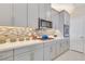 Contemporary kitchen with modern gray cabinets, stainless steel appliances, and stylish backsplash at 2555 Hampton Rd # 7304, Henderson, NV 89052