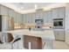 Modern kitchen featuring sleek gray cabinets, stainless steel appliances, and a center island with seating at 2555 Hampton Rd # 7304, Henderson, NV 89052