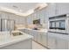 Stylish kitchen with stainless steel appliances, gray cabinets, and a mosaic tile backsplash at 2555 Hampton Rd # 7304, Henderson, NV 89052