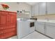 Functional laundry room with front loading machines and cabinet space at 2555 Hampton Rd # 7304, Henderson, NV 89052