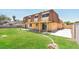 Expansive backyard featuring a well-manicured lawn, covered patio, and mature trees, perfect for outdoor living at 2614 Capistrano Ave, Las Vegas, NV 89121