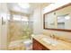 Bathroom features a glass enclosed shower, tile, and granite vanity at 2614 Capistrano Ave, Las Vegas, NV 89121
