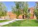 Charming home with lovely landscaping, a well-maintained lawn, and a welcoming front entrance at 2614 Capistrano Ave, Las Vegas, NV 89121