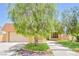 Charming single-Gathering home showcasing a spacious front yard, inviting landscaping, and classic architectural details at 2614 Capistrano Ave, Las Vegas, NV 89121