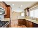 Modern kitchen featuring granite countertops, stainless steel appliances, and stylish wood cabinetry at 2614 Capistrano Ave, Las Vegas, NV 89121
