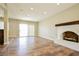 Spacious living room with fireplace, hardwood floors, and a sliding glass door for natural light at 2614 Capistrano Ave, Las Vegas, NV 89121