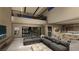 Open living room featuring high ceilings, modern decor, and seamless flow to the kitchen at 2655 Juniper Branch St, Las Vegas, NV 89117