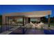 Modern outdoor pool with a patio area featuring a pool table, bar, fire pit, and lush landscaping at 2655 Juniper Branch St, Las Vegas, NV 89117