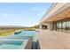 This backyard with a pool, spa, and kitchen features outdoor dining and a golf course view at 2695 Ponte Vecchio Ter, Henderson, NV 89052