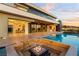Luxury backyard featuring a pool, fire pit, and seamless indoor/outdoor living experience at 2695 Ponte Vecchio Ter, Henderson, NV 89052