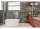 The spacious bathroom boasts marble walls, granite countertops, a bathtub, and stylish fixtures at 2695 Ponte Vecchio Ter, Henderson, NV 89052