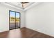 This bedroom features a ceiling fan, hardwood floors, and large windows with neighborhood views at 2695 Ponte Vecchio Ter, Henderson, NV 89052