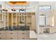The luxurious walk-in closet features custom built-in shelves, and a center island at 2695 Ponte Vecchio Ter, Henderson, NV 89052