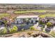 Modern home with large glass windows, desert landscaping, and a spacious driveway overlooking a golf course and neighborhood at 2695 Ponte Vecchio Ter, Henderson, NV 89052