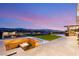 Outdoor fire pit lounge area with views of the valley and city lights at sunset at 2695 Ponte Vecchio Ter, Henderson, NV 89052