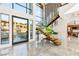 A grand foyer features a modern floating staircase, marble floors, and ample natural light at 2695 Ponte Vecchio Ter, Henderson, NV 89052