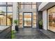 Elegant entryway featuring black marble tile, modern planters, and a grand glass front door at 2695 Ponte Vecchio Ter, Henderson, NV 89052