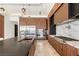 Modern kitchen with stainless steel appliances, custom wood cabinets, and marble backsplash at 2695 Ponte Vecchio Ter, Henderson, NV 89052