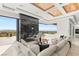 An open living room features a marble fireplace wall and a glass door with a beautiful mountain view at 2695 Ponte Vecchio Ter, Henderson, NV 89052