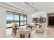 Open-concept living room with large windows, sleek furniture, and picturesque mountain and pool views at 2695 Ponte Vecchio Ter, Henderson, NV 89052