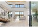 Bright and airy living room with floor-to-ceiling windows offering stunning views and a modern staircase at 2695 Ponte Vecchio Ter, Henderson, NV 89052