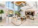 Elegant living room with soaring ceilings, modern furnishings, and natural light from large windows at 2695 Ponte Vecchio Ter, Henderson, NV 89052