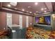 Private movie room with large screen, plush carpeting, and custom lighting for the ultimate viewing experience at 2695 Ponte Vecchio Ter, Henderson, NV 89052
