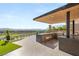 An outdoor kitchen with a grill and bar has stunning views of mountains and the golf course at 2695 Ponte Vecchio Ter, Henderson, NV 89052