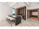 Entertainer's wet bar with modern bar stools, elegant display shelving, and wine storage at 2695 Ponte Vecchio Ter, Henderson, NV 89052