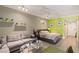 This condo has a modern interior with neutral walls, bright green accent wall and laminate flooring at 30 Strada Di Villaggio # 429, Henderson, NV 89011