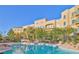 Exterior view of the condo buildings with a community pool and clear blue skies at 30 Strada Di Villaggio # 429, Henderson, NV 89011