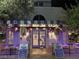 Charming storefront featuring awning, outdoor seating, and lush floral arrangements for a inviting ambiance at 30 Strada Di Villaggio # 429, Henderson, NV 89011