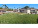 Spacious backyard with lush green lawn, pool, and patio areas, perfect for outdoor entertaining at 3104 Conners Dr, Las Vegas, NV 89107