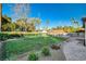 Expansive backyard with mature landscaping, brick patio, lush lawn and a glimpse of the pool house at 3104 Conners Dr, Las Vegas, NV 89107