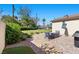 Relaxing backyard patio with outdoor seating, a grill, and lush greenery at 3104 Conners Dr, Las Vegas, NV 89107