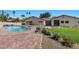 Inviting backyard with a swimming pool, brick patio, and comfortable outdoor seating area at 3104 Conners Dr, Las Vegas, NV 89107