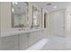 Bright bathroom featuring a dual sink vanity, marble floors, and modern fixtures at 3104 Conners Dr, Las Vegas, NV 89107