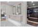 Bright bathroom featuring dual vanity, marble floors, and a spacious walk-in closet at 3104 Conners Dr, Las Vegas, NV 89107