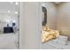 Bathroom featuring an illuminated onyx sink, wall mirror, and access to a bedroom at 3104 Conners Dr, Las Vegas, NV 89107