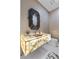 Modern bathroom featuring a stylish, illuminated marble sink and unique decorative mirror at 3104 Conners Dr, Las Vegas, NV 89107