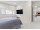 Clean bedroom with a large mounted tv, neutral decor, and a glimpse into the rest of the house at 3104 Conners Dr, Las Vegas, NV 89107