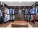A custom walk-in closet with ample shelving, drawers, and a central ottoman at 3104 Conners Dr, Las Vegas, NV 89107