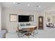 Bright open-concept dining area featuring marble table, modern lighting and decor, with comfortable seating at 3104 Conners Dr, Las Vegas, NV 89107