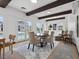 Bright dining room featuring wood beam ceiling, modern decor, and access to the outdoor pool area at 3104 Conners Dr, Las Vegas, NV 89107
